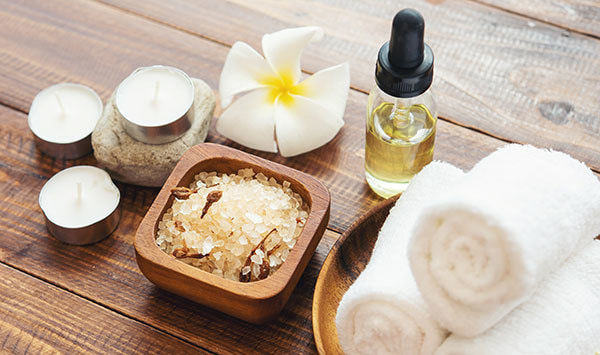 sea-salt-towels-aroma-oil-in-bottles-and-flowers-on-vintage-wooden-background.jpg